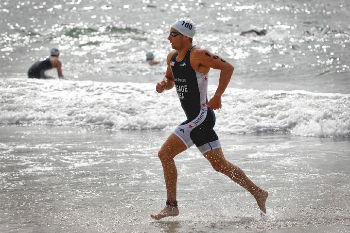 Solo male runner jogging on a beach